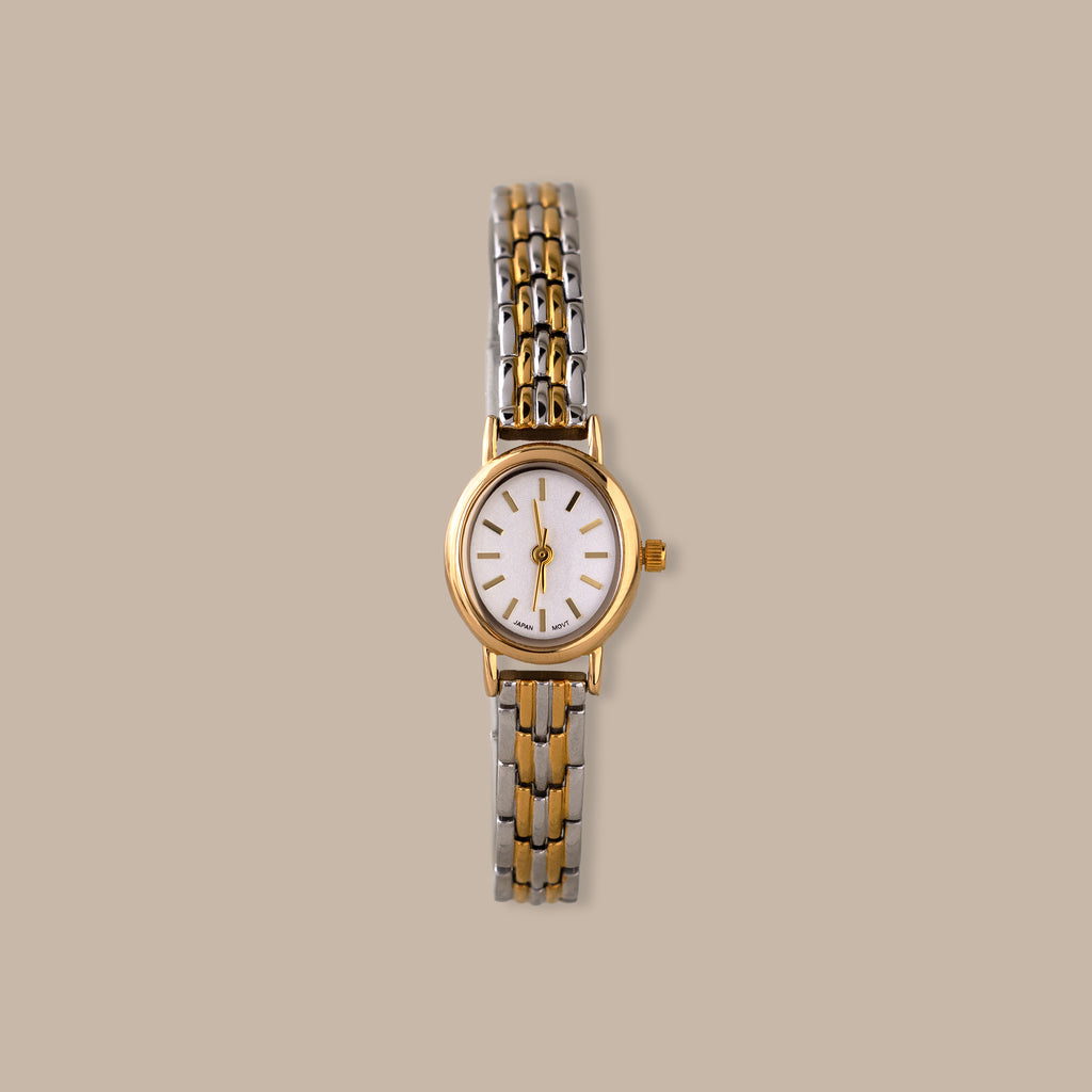 Balance Oval Link Timepiece: gold-tone watch with a minimalist dial and polished two-tone link bracelet.
