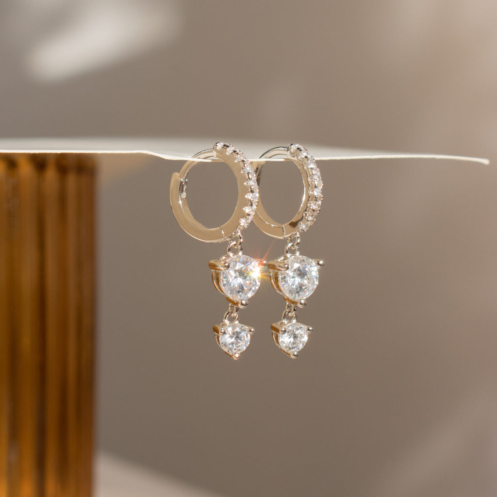 Caroline Pave Drop Huggies in Silver: sparkling hoops with teardrop and round crystals, designed for elegant shine—perfect for those who love timeless, embellished earrings.