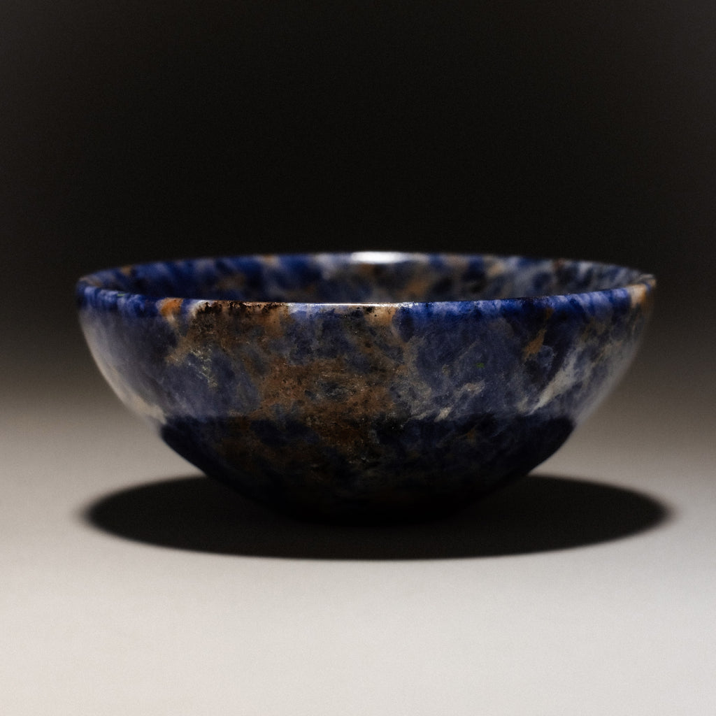 Natural blue and brown gemstone ring dish with unique stone patterns.