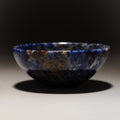 Natural blue and brown gemstone ring dish with unique stone patterns.