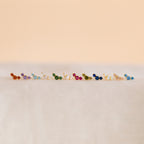 Bella Birthstone Studs—small, colorful studs displayed on a soft, neutral surface—make the perfect personalized jewelry gift for mothers and daughters.