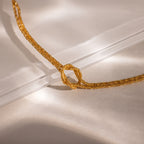 Close-up of the Rope Knot Chain Bracelet in gold with a center knot detail, displayed against a neutral background.