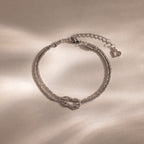 Rope Knot Chain Bracelet in silver with a center knot detail and duo chain design, displayed on a neutral background.