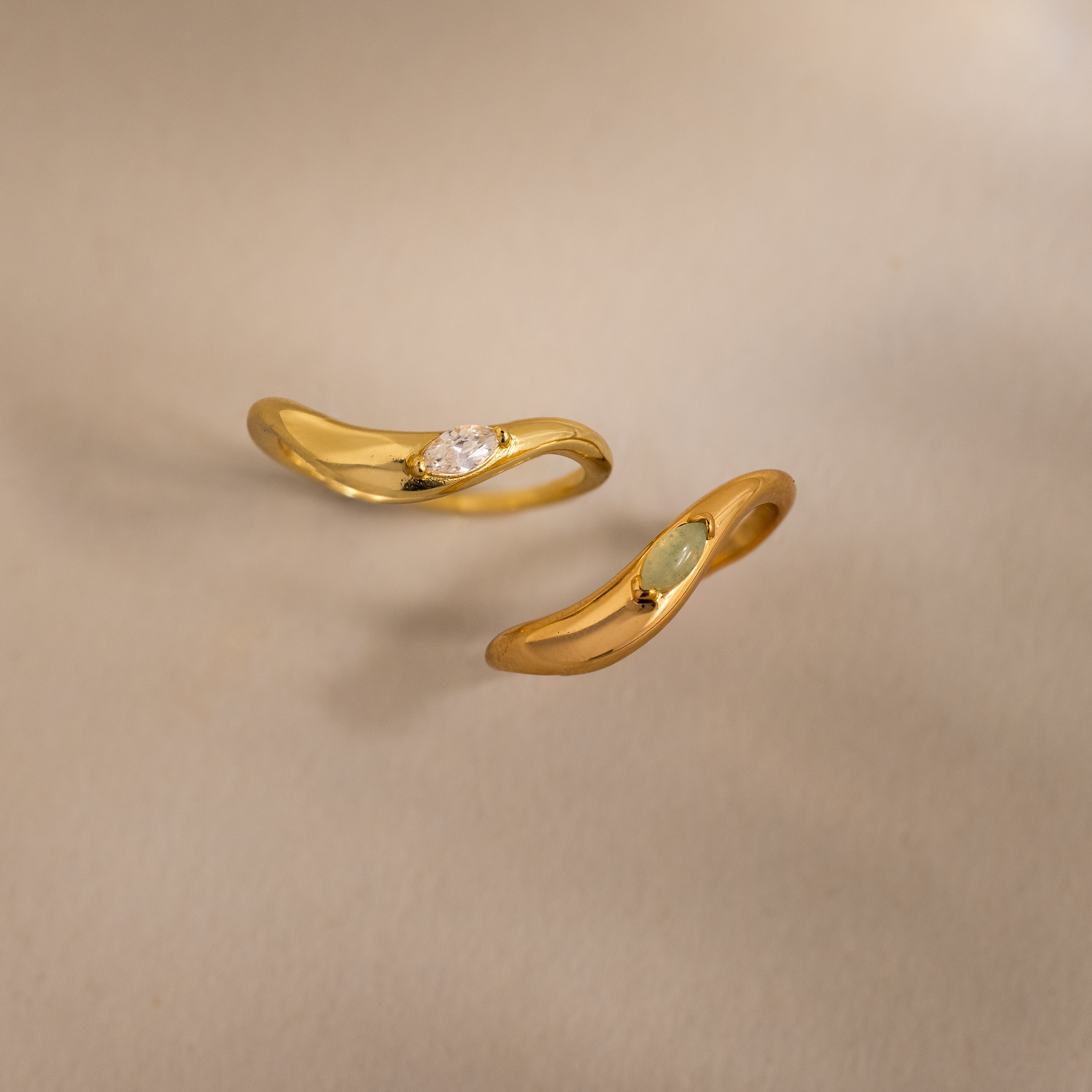 Two Zen Gemstone Curve Rings with curved bands and subtle gemstone accents are shown on a neutral background—ideal minimalist rings.