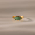 Marquise Jade Signet Ring with a marquise-shaped green jade stone shown on a neutral, softly lit background.