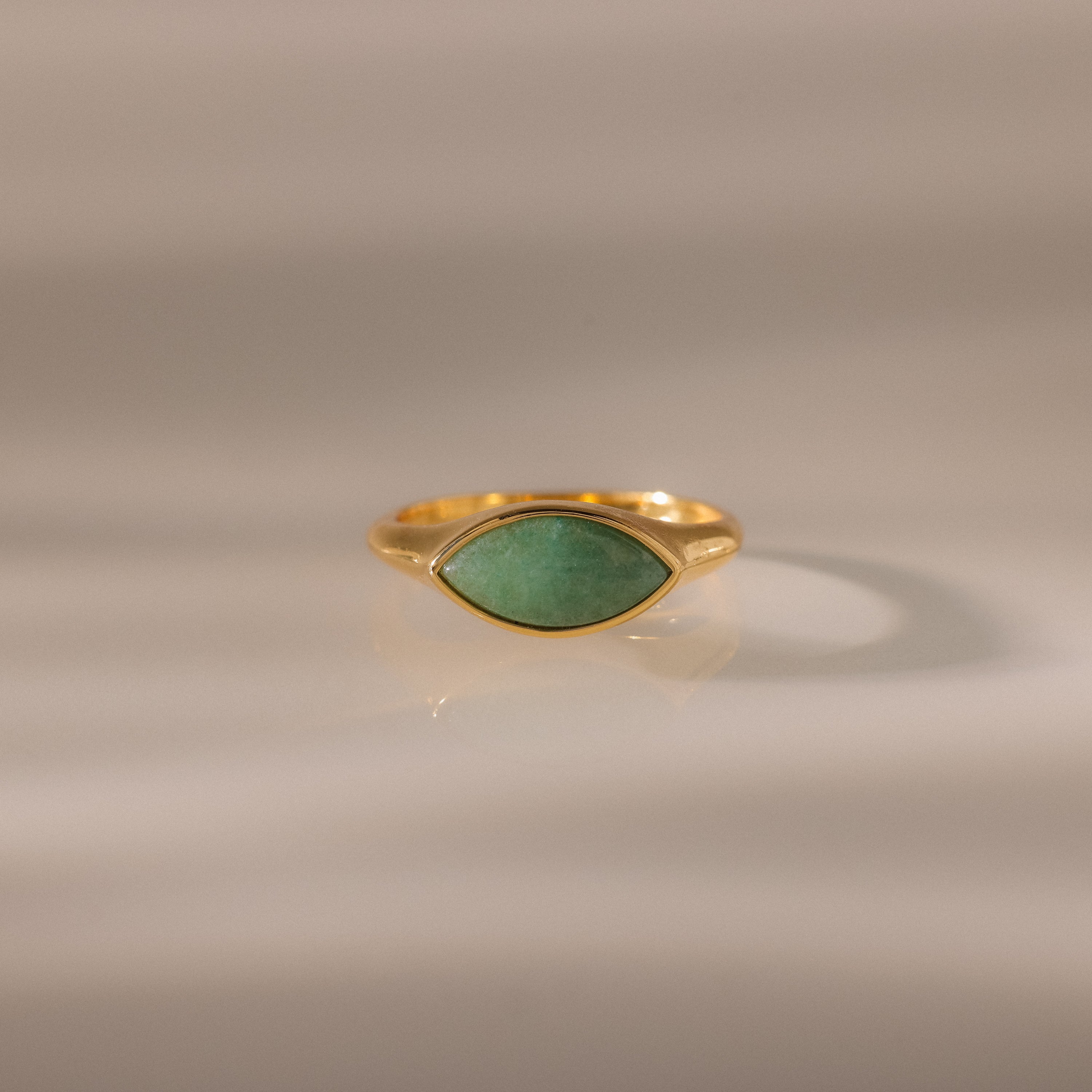 Marquise Jade Signet Ring with a marquise-shaped green jade stone shown on a neutral, softly lit background.
