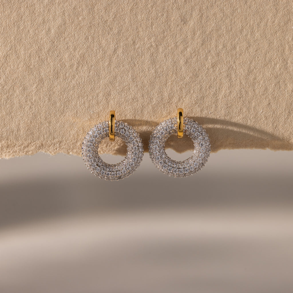 Mixed Metal Pave Circle Studs displayed on textured beige paper.