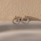 Mixed Metal Pave Circle Studs displayed on textured beige paper.