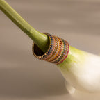 The Endless Eternity Alexandrite Ring is displayed on the stem of a fresh green and white vegetable, highlighting its elegant, colorful sparkle in a vibrant setting.
