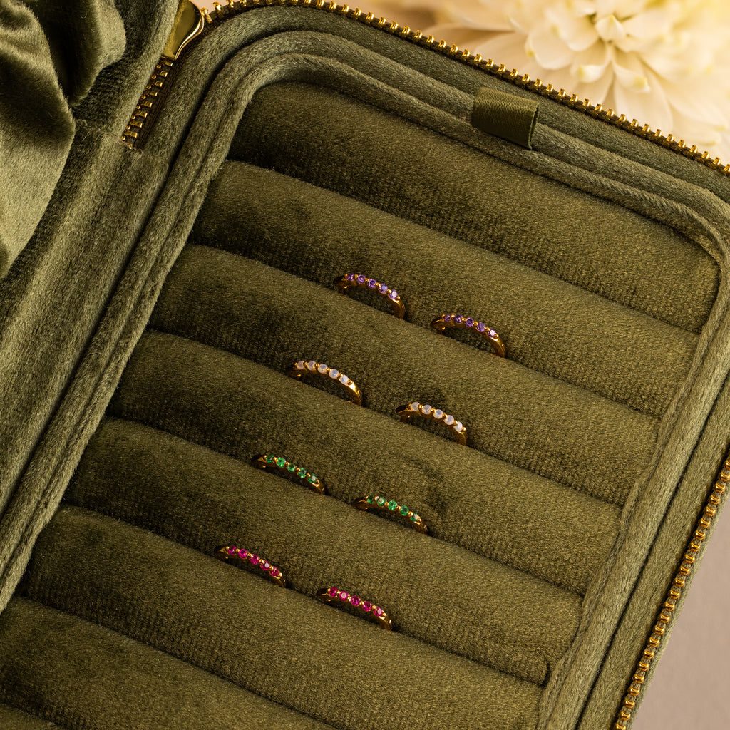 Inside Out Aquamarine Huggies displayed in a green velvet jewelry case with a flower in the background—perfect for pairing with your favorite gemstone rings or stacking earrings.