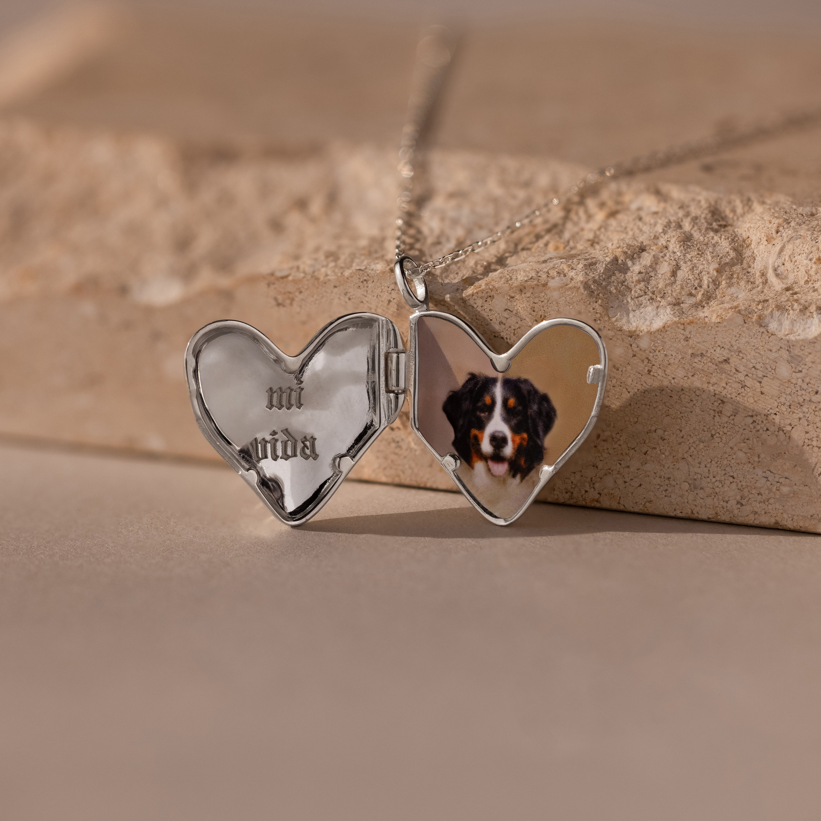 The Organic Heart Locket Necklace in Sterling Silver opens to display a dog’s photo and the engraved words "mi vida" inside—ideal keepsake jewelry for cherishing special memories.