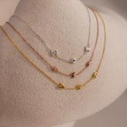 The Multiple Bubble Letter Necklace, shown with custom charms spelling MOH, curz, and jana on a neutral mannequin, offers a playful boho vibe—perfect for personalizing your style.