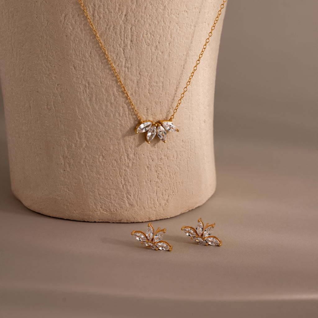 The Marquise Diamond Jewelry Set features a gold necklace and matching earrings with leaf-shaped, diamond-like stones—a stunning choice for wedding jewelry.