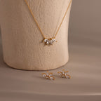 The Marquise Diamond Jewelry Set features a gold necklace and matching earrings with leaf-shaped, diamond-like stones—a stunning choice for wedding jewelry.