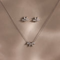 Marquise Diamond Jewelry Set in Sterling Silver: Features a necklace and earrings with leaf-inspired, diamond-like designs—perfect for bridal wear, elegantly presented on a neutral beige background.