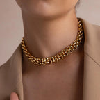 A person wears the Chunky Link Mesh Necklace, a bold gold chain choker, styled with a beige blazer and shown from the neck to upper chest.