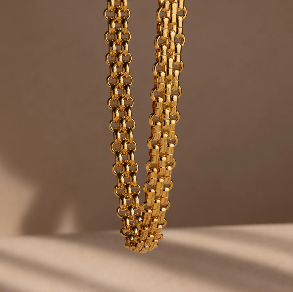 Close-up of the Chunky Link Mesh Necklace featuring thick, interlocking links against a beige background—ideal for anyone who loves bold, statement jewelry.