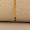Close up of a Gold North Star Birthstone Necklace with a Purple Amethyst Gemstone.