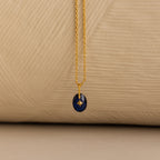Close up of a Gold North Star Birthstone Necklace with a Blue Sapphire Gemstone.