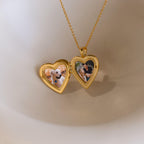 Up close of gold heart-shaped locket pendant necklace opened with 2 personal photos inside.