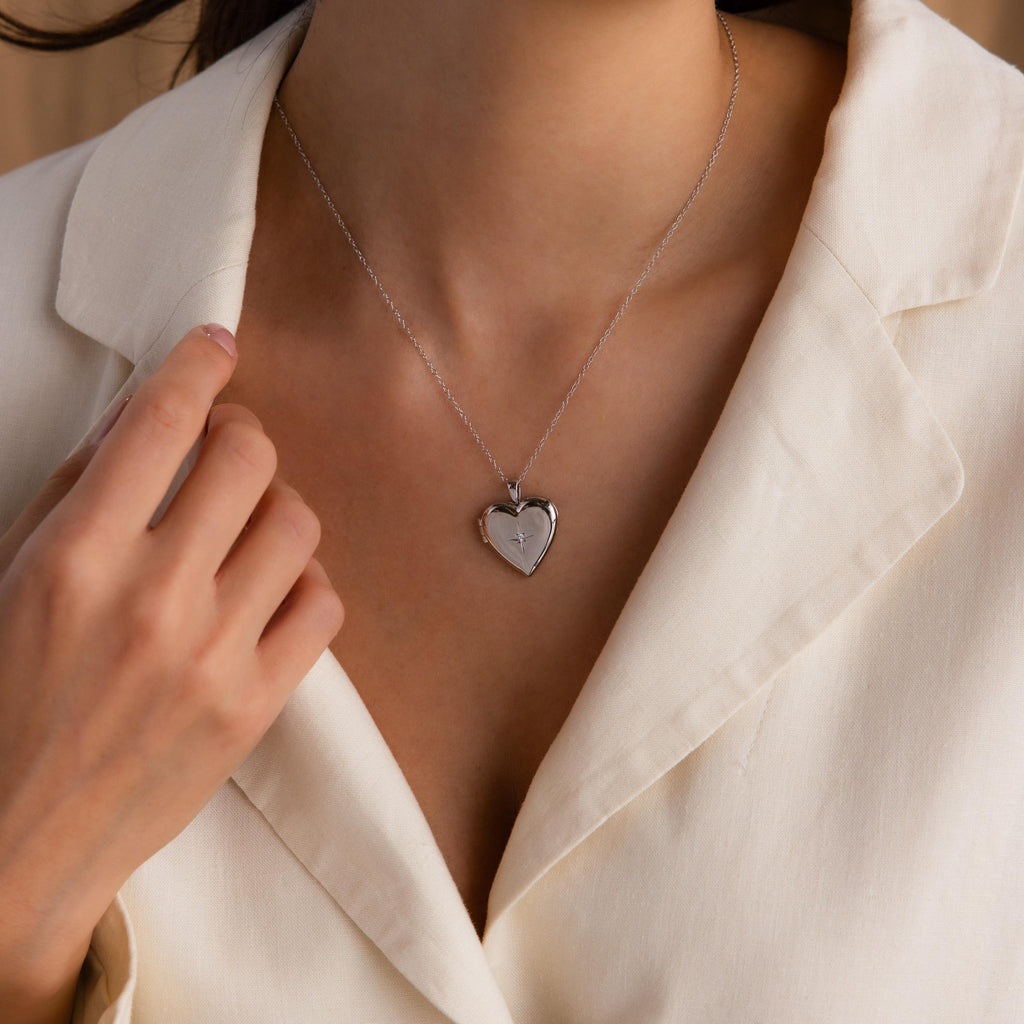 Model wearing a Silver CZ Diamond North Star Heart Locket Necklace.