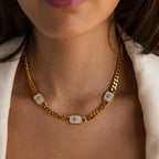Model wearing a Gold Curb Chain Necklace with three North Star Opal Charms.