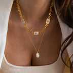 Model wearing a Gold North Star Opal Necklace layered with a Pave Pearl Initial Pendant Necklace.