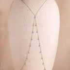 Sterling silver Diamond Station Body Chain draped on a textured bust form, showing the elegant fall and symmetrical crystal arrangement of the chain.