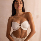 Full view of the model wearing the gold Diamond Station Body Chain, paired with a pearl diamond necklace and  a simple satellite waist chain.