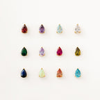 Twelve teardrop-shaped, multicolored gemstone earrings with gold settings—pair them with the Ophelia Birthstone Necklace for a perfectly coordinated look.