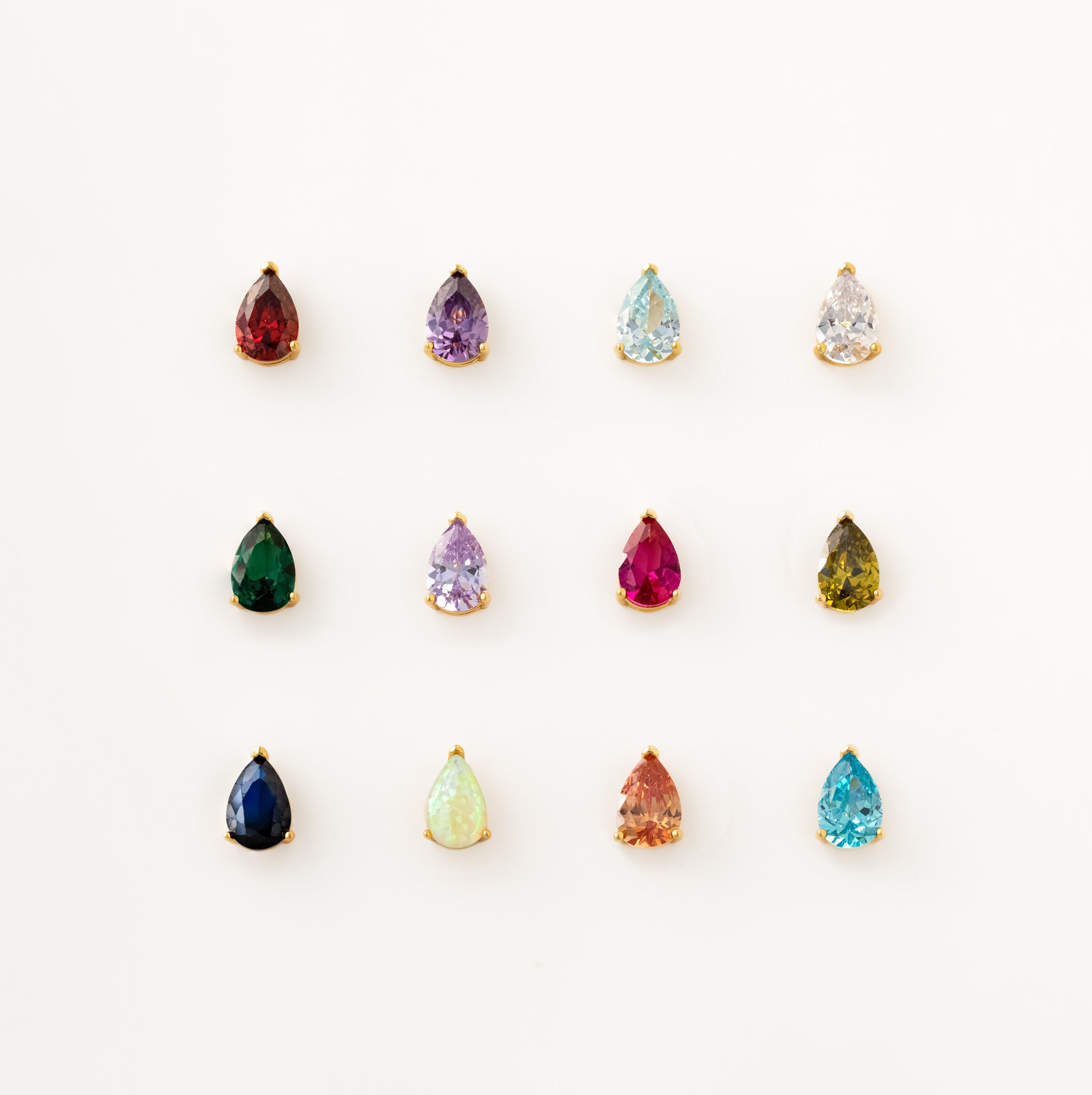 Twelve teardrop-shaped, multicolored gemstone earrings with gold settings—pair them with the Ophelia Birthstone Necklace for a perfectly coordinated look.