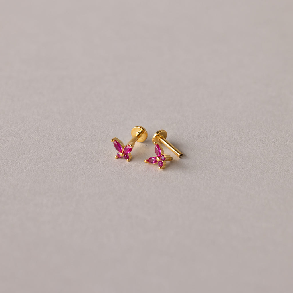 Butterfly Garnet Flatback Studs with pink gemstones on a light grey background—perfect personalized jewelry for any occasion.