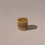 The Marquise Infinity Birthstone Ring, with vibrant gemstones arranged in multiple rows, rests on a neutral background and casts a gentle shadow.