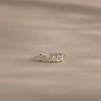 Close up of a dainty silver bubble letter ring with the name "GRACE".