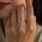 Close-up of a woman wearing a silver custom initial ring with bubble letters H and G on her finger.