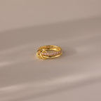 Duo Birthstone Tennis Linked Ring Set in Pink Tourmaline (October), featuring gold links and three small gold loops, displayed on a soft beige surface.