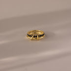 The Duo Birthstone Tennis Linked Ring Set in Onyx is displayed on a light, reflective surface.