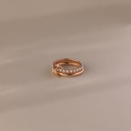 The Duo Opal Tennis Linked Ring Set features a delicate gold beaded design with interlocking loops, beautifully presented on a neutral background.