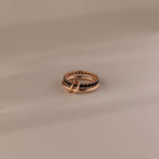 The Duo Onyx Tennis Linked Ring Set features two intertwined rings, one adorned with a textured, beaded design—an elegant pairing ideal for stacking with your favorite minimalist rings—beautifully displayed on a neutral background.