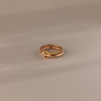 The Duo Topaz Tennis Linked Ring Set features small stones and a decorative loop, elegantly displayed on a neutral background.