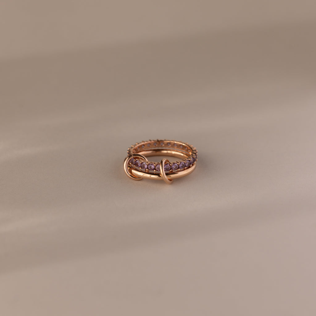 Duo Alexandrite Tennis Linked Ring Set with purple gemstones and an intertwined band design, displayed on a neutral background.