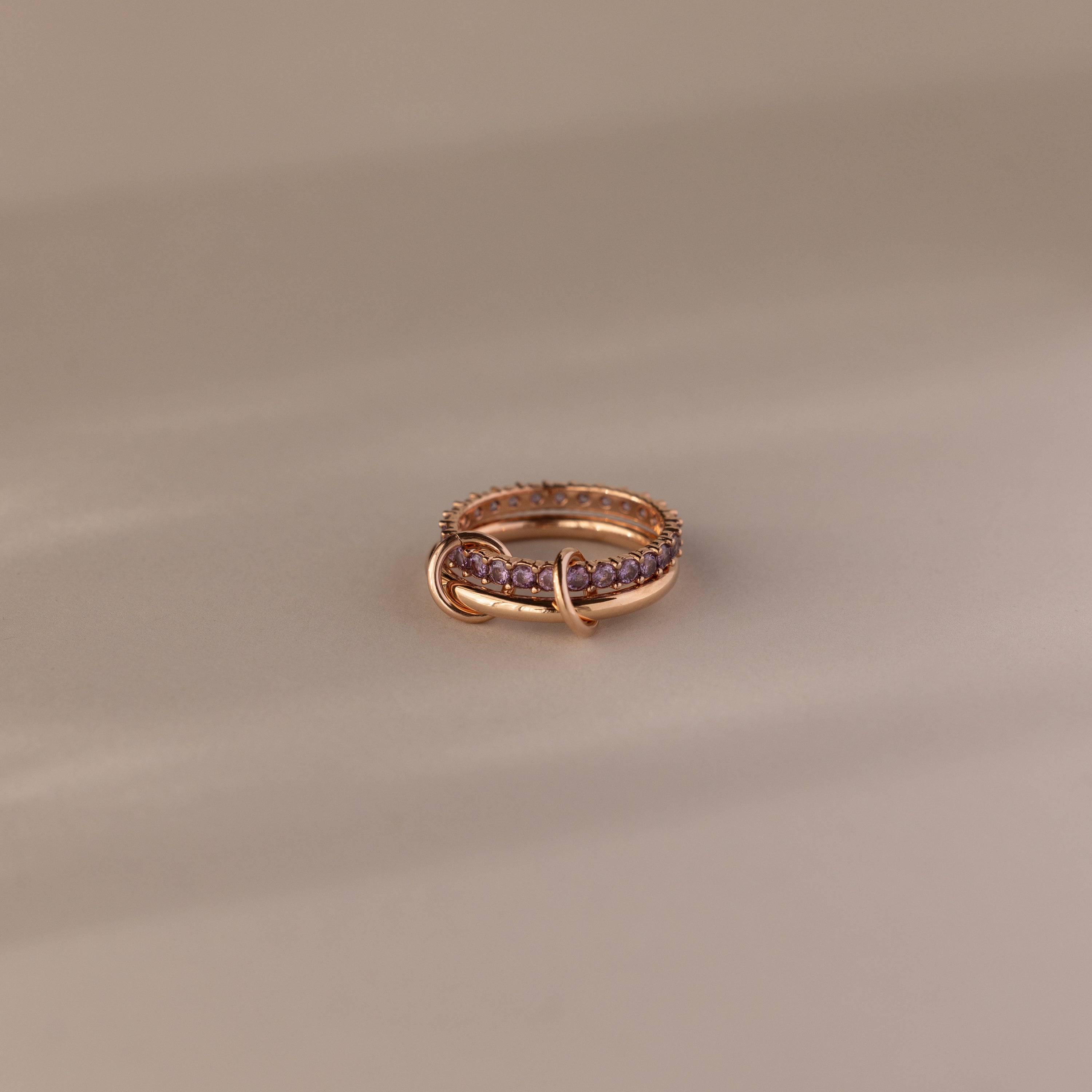 Duo Alexandrite Tennis Linked Ring Set with purple gemstones and an intertwined band design, displayed on a neutral background.