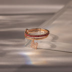 The Linked Initial Ruby Ring Set showcases vibrant red stones on a clear surface, ideal as a personalized birthstone ring or paired with a pavé initial charm for extra sparkle.