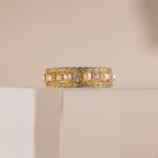 The Diamond Eternity Ring Set is elegantly displayed on a clear, glossy stand against a beige background.