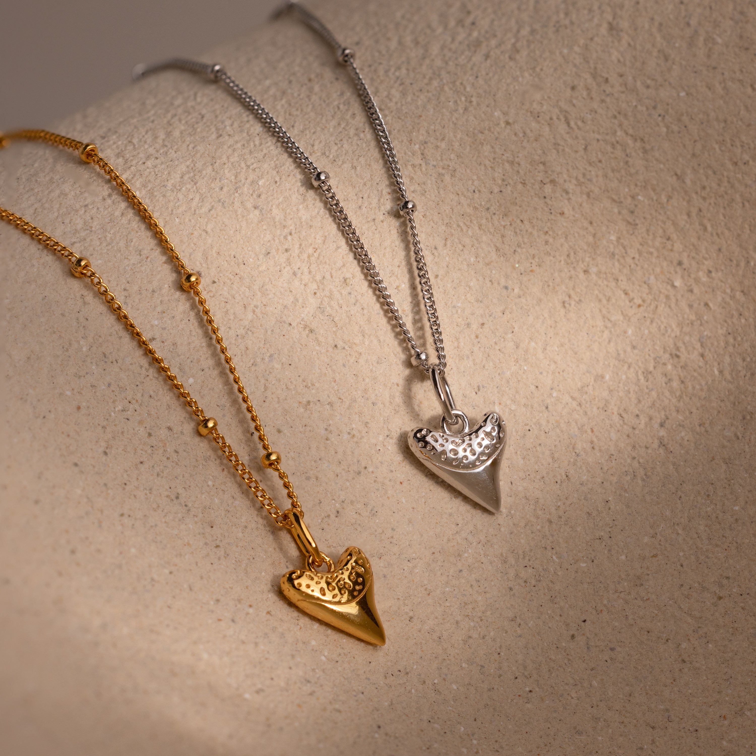 The Shark Tooth Necklace, available in both gold and silver finishes, brings a subtle beachside vibe—making it a standout in any coastal-inspired jewelry collection.