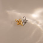 The Dainty Shark Tooth Charm in Silver captures coastal jewelry vibes, featuring textured details and displayed on a neutral background with soft, elegant light reflections.
