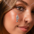 Close-up of a woman wearing the Fish Pendant Necklace in Silver, showcasing her face and the ocean-inspired jewelry.