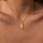The Fish Pendant Necklace in 18K Gold, worn close to the skin, features an elegant ocean-inspired design—perfect for layering with your favorite pieces.