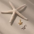 The Pave Starfish Charm in Silver shines on a soft beige background, adding coastal charm and elegance to your jewelry collection.
