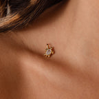Close-up of the Diamond Turtle Charm in 18K Gold, featuring a clear gemstone and diamond-detailed shell, worn on an earlobe for a stunning ocean-inspired look.